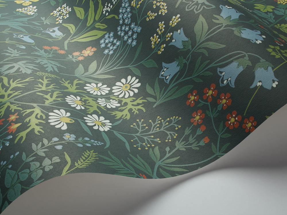 Colored in rich hues of blue, green, red, white and yellow on a dramatic midnight blue backdrop, our Flora wallpaper takes you out into the delights of a spring meadow at night.