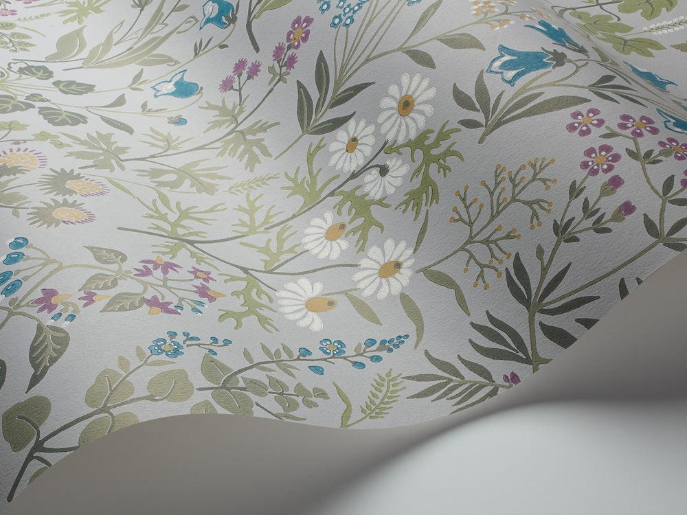 Colored in playful hues of green, gold, blue and purple across a soft blue-grey backdrop, our Flora wallpaper is light, bright and optimistic.