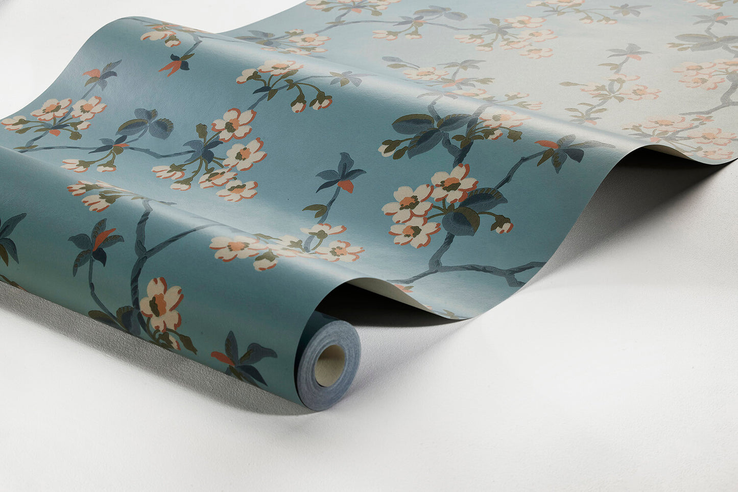 Set on a pastel blue background with green, white and pale orange detailing, our Trädgårdsstaden wallpaper offers a truly calm and classic style.
