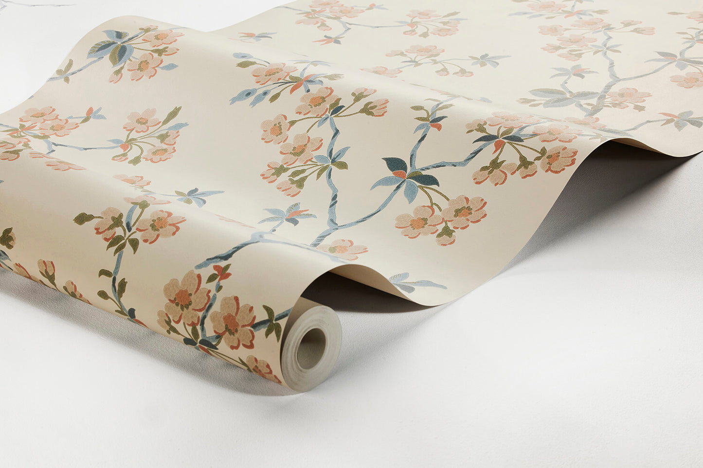 Set on a neutral beige background with floral detailing in blue, green and orange, our Trädgårdsstaden wallpaper depicts the sublime sights and sweet scents of springtime in Japan.