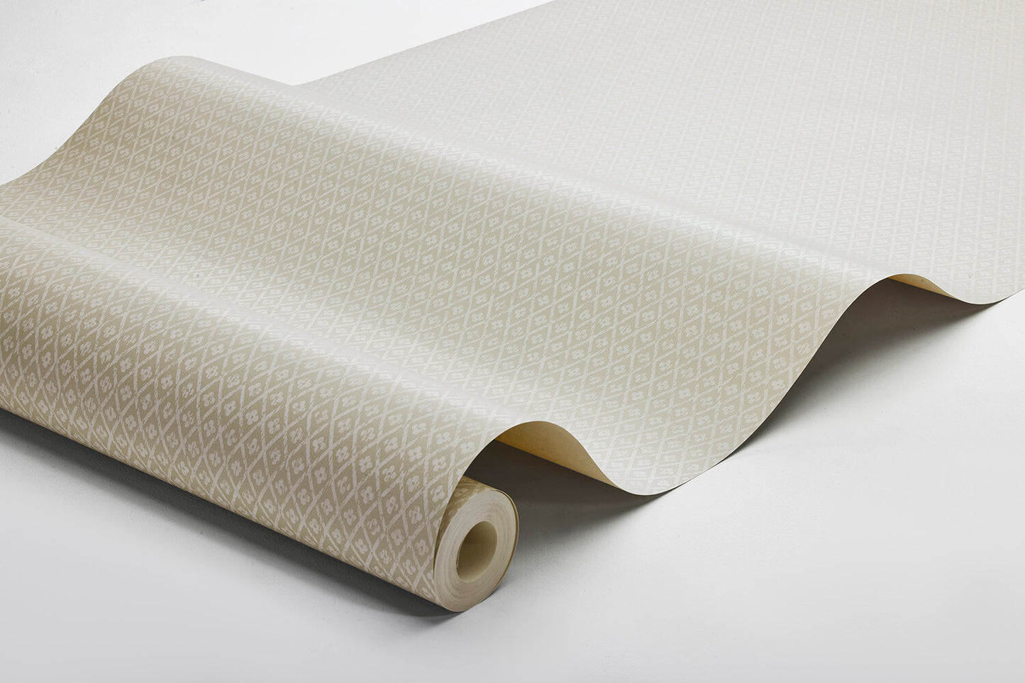 Willowherb wallpaper is simple and rustic. Having the appearance of a single-color surface from a distance, its pretty petite design features a stylized four-petal flower within a diamond trellis pattern.
