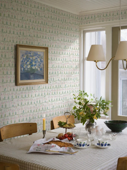 Our sublime Linnea wallpaper has delicate stylized florals in pink, green, and blue on a fresh white backdrop. Originally designed for porcelain in the 1960s by celebrated Scandinavian designer Stig Lindberg, we have retained all nine colors of the original palette thanks to a special printing technique.