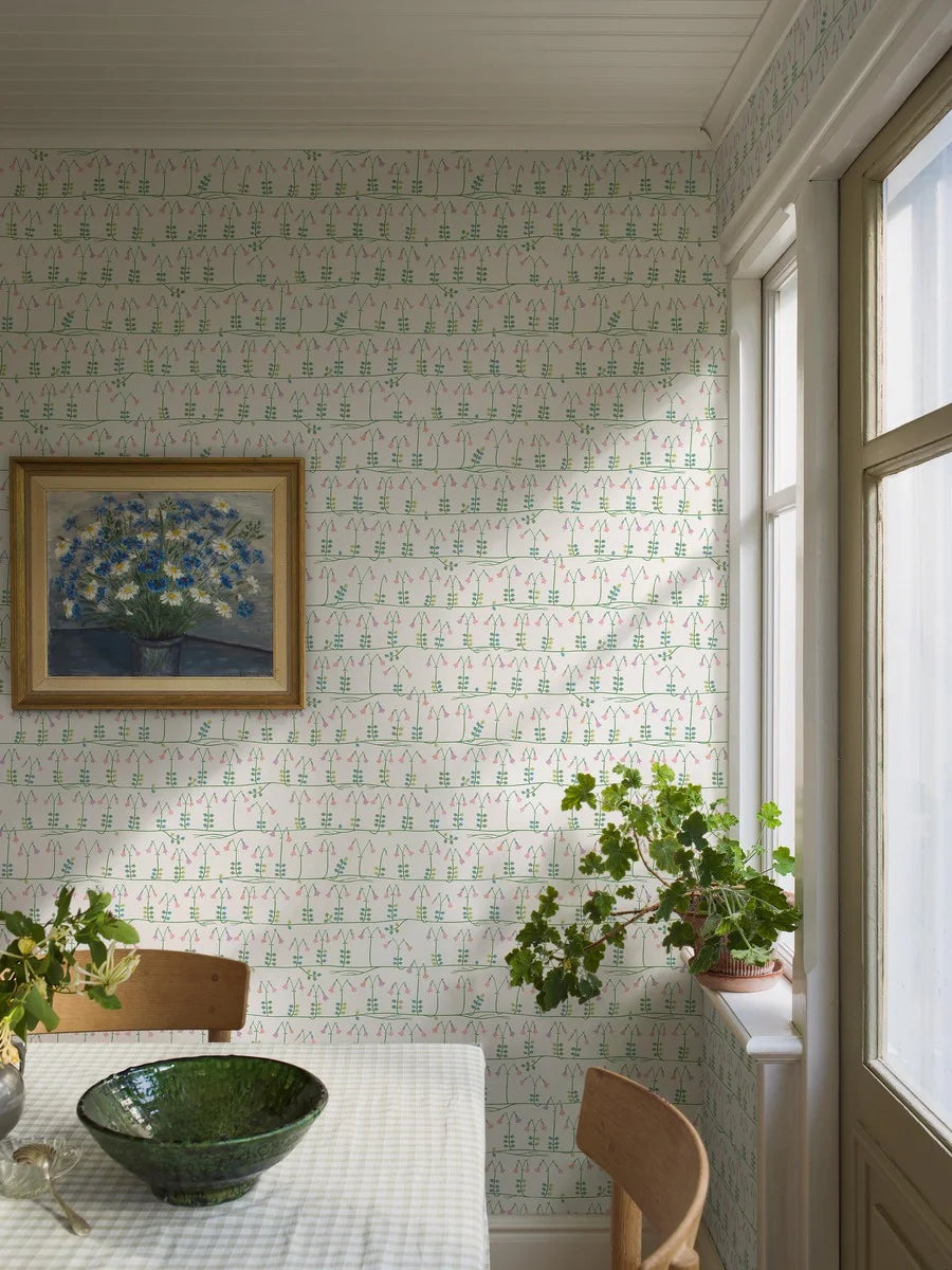 Our sublime Linnea wallpaper has delicate stylized florals in pink, green, and blue on a fresh white backdrop. Originally designed for porcelain in the 1960s by celebrated Scandinavian designer Stig Lindberg, we have retained all nine colors of the original palette thanks to a special printing technique.
