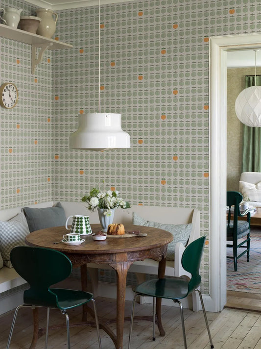  This version of our Pall wallpaper reimagines Stig Lindberg’s iconic porcelain design with soft green apples punctuated with the occasional apple in a lively shade of yellow-orange. 