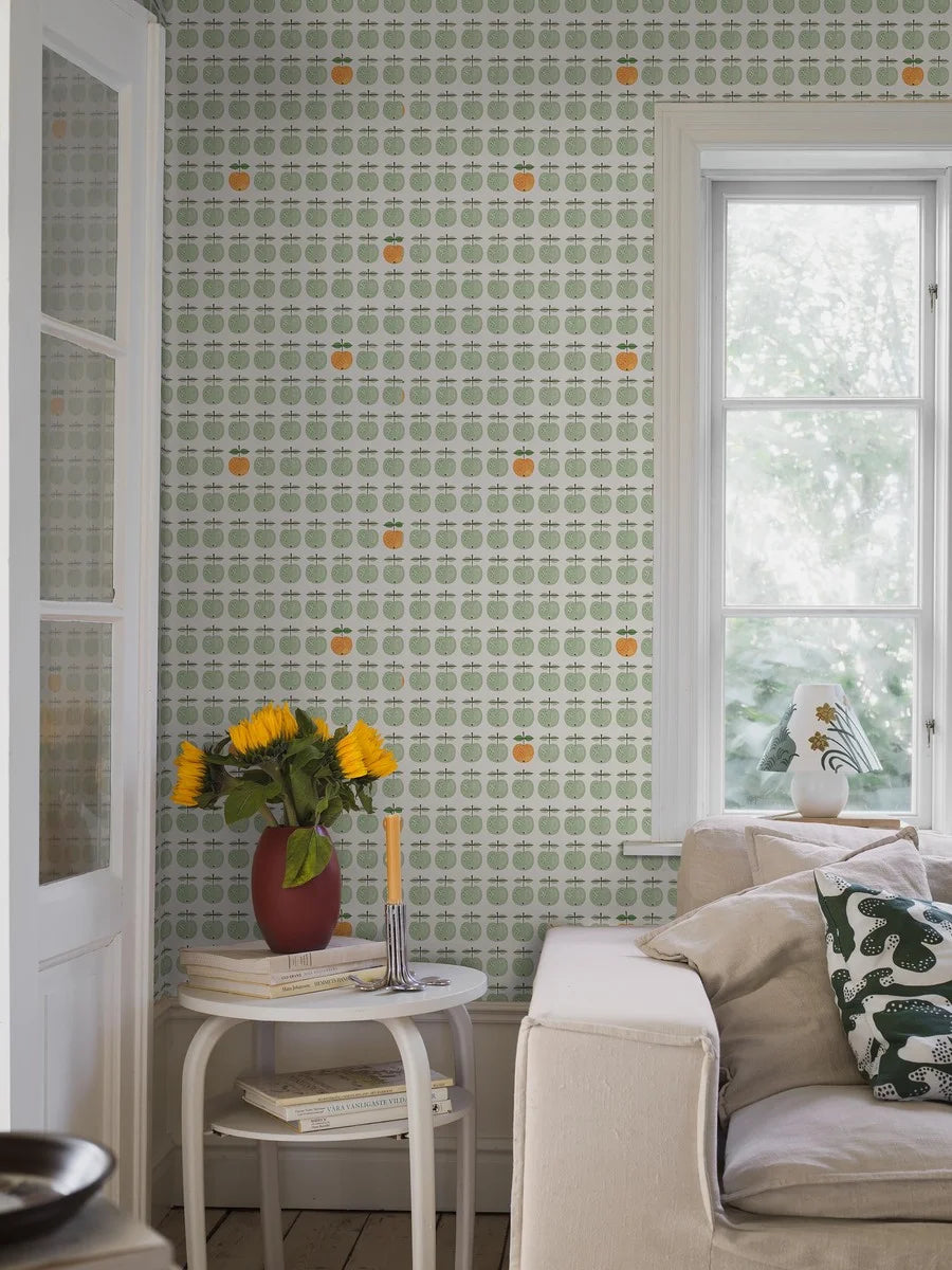  This version of our Pall wallpaper reimagines Stig Lindberg’s iconic porcelain design with soft green apples punctuated with the occasional apple in a lively shade of yellow-orange. 