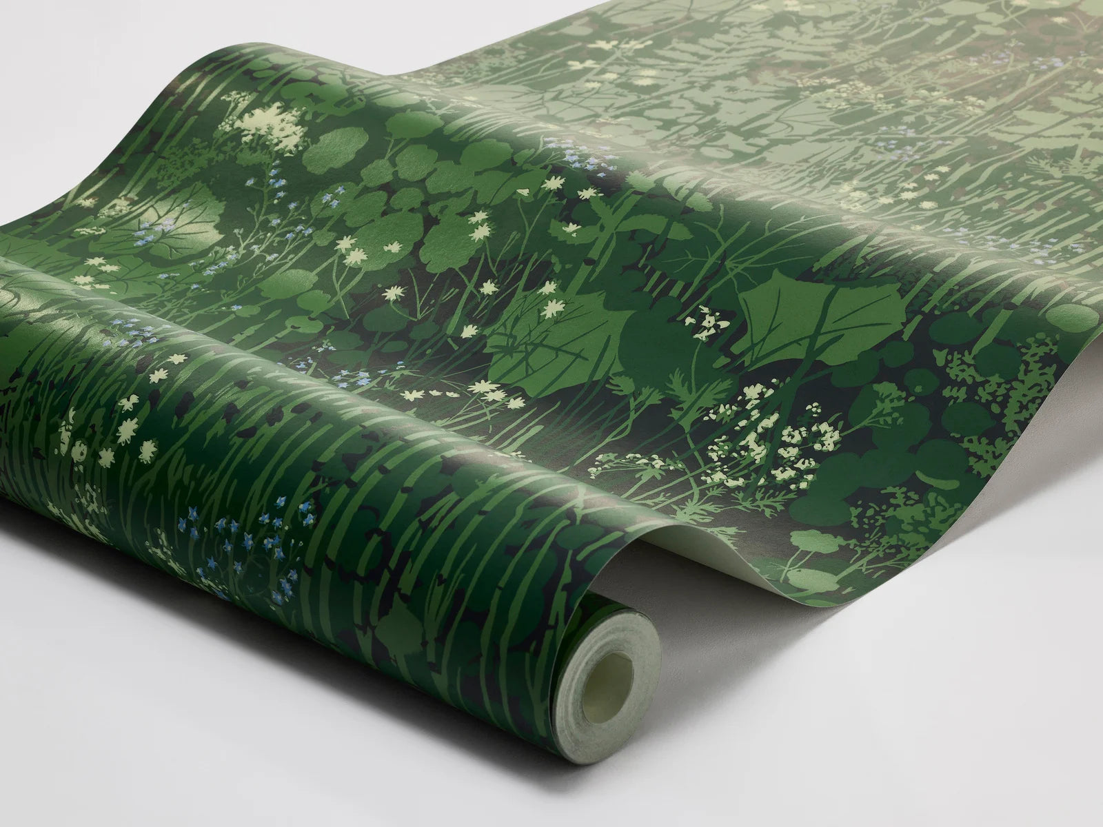 Capturing a lush green verge, our Dikesren wallpaper is a vibrant tribute to nature’s beauty. Originally created for textile in 1944, this iconic design by Arne Jacobsen features ferns, forget-me-nots, and wildflowers on deep green ground.