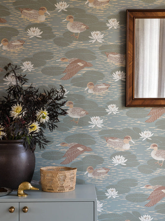 Wallpaper with beautifully patterned ducks camouflage with the water lily pads in a luscious design that gives any room a snug yet cool atmosphere.