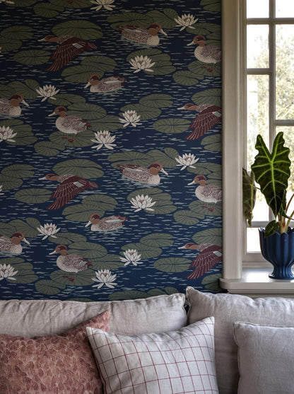 Wallpaper with beautifully patterned ducks camouflage with the water lily pads in a luscious design that gives any room a snug yet cool atmosphere.