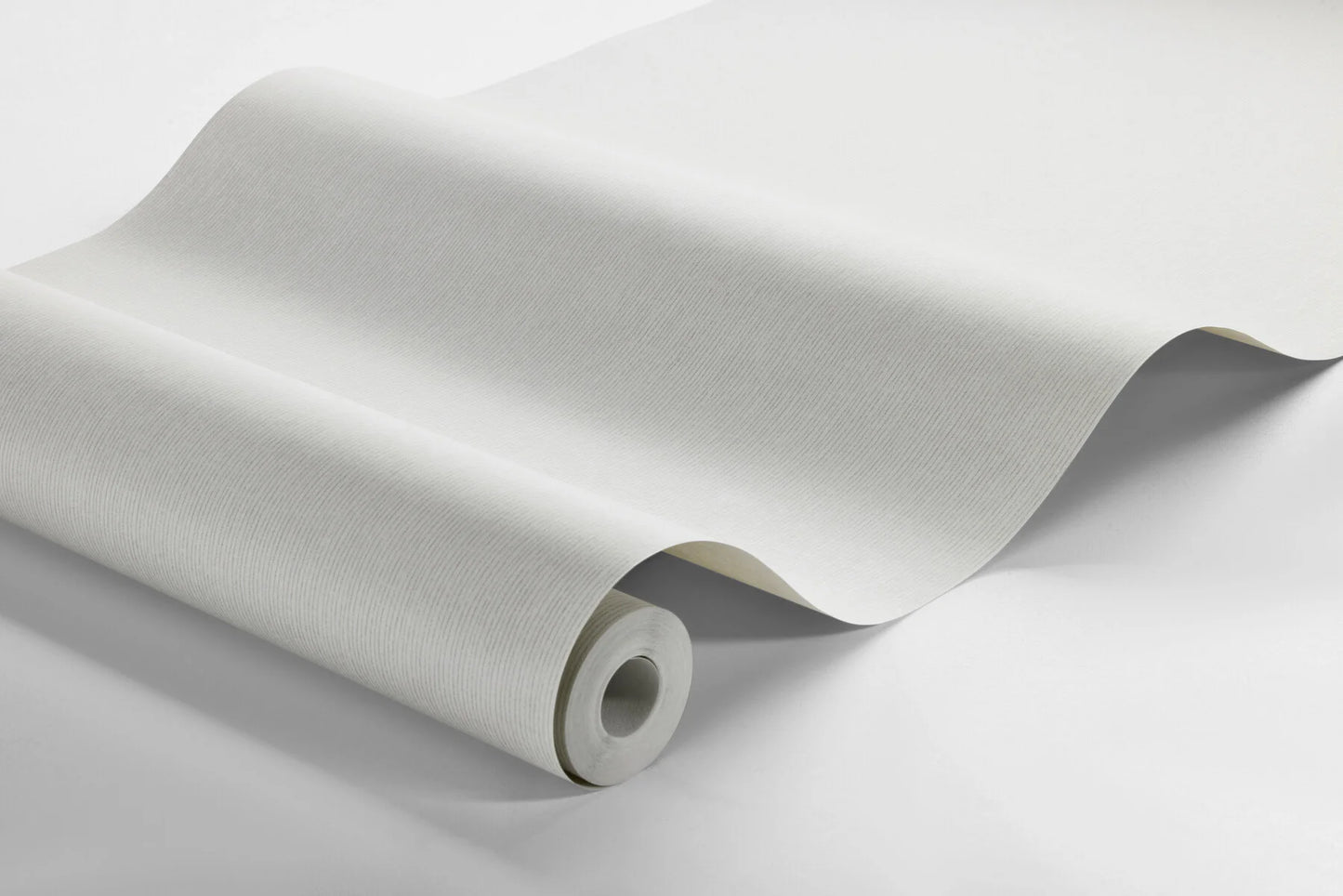 Elevate your walls with our Adam wallpaper in a neutral light grey hue for discreet depth and sophistication. 
