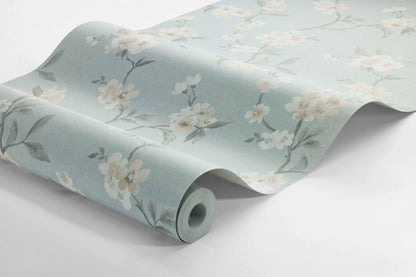  Colored in a dreamy palette on a pale blue background, our Marie wallpaper enchants your space with its watercolor-painted cherry branches. 