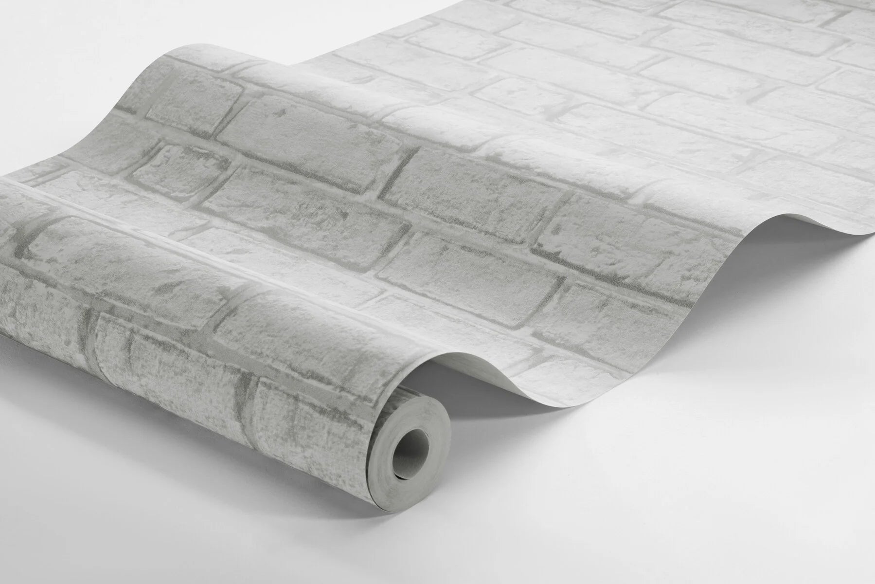 Colored in warm, grey shades, our Birk wallpaper with its cement, lime-like surface breathes a unique and inviting expression into your home. 