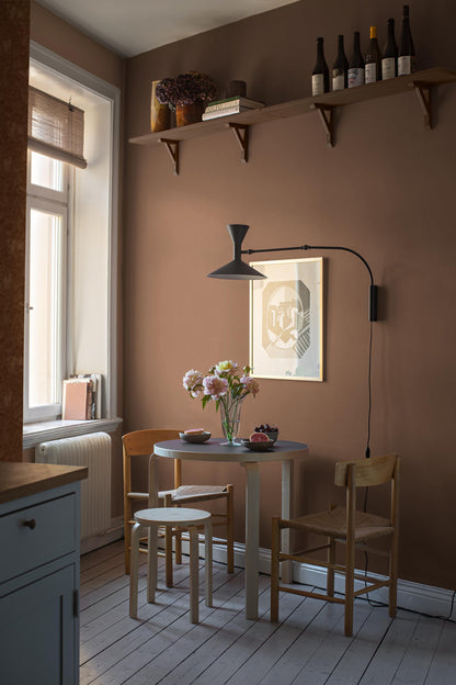 Deep Terra is a rich terracotta-colored wallpaper with a warm, earthy character. The wallpaper has a tactile linen texture that gives the color depth and a vibrant expression