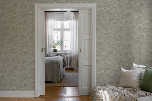 Sonja is a classic floral wallpaper with a modern twist. Light flowers on stems and dots spread across the surface. 