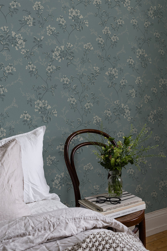 Sonja is a classic floral wallpaper with a modern twist. Light flowers on stems and dots spread across the surface. 