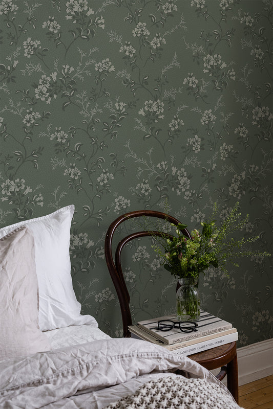 Sonja is a classic floral wallpaper with a modern twist. Light flowers on stems and dots spread across the surface.