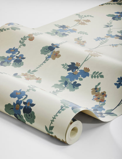 Colored in a palette of misty blue, brown and cool green-blue on a linen background, our Vera wallpaper in collagraph print features a 1920’s vintage pattern from our archives.