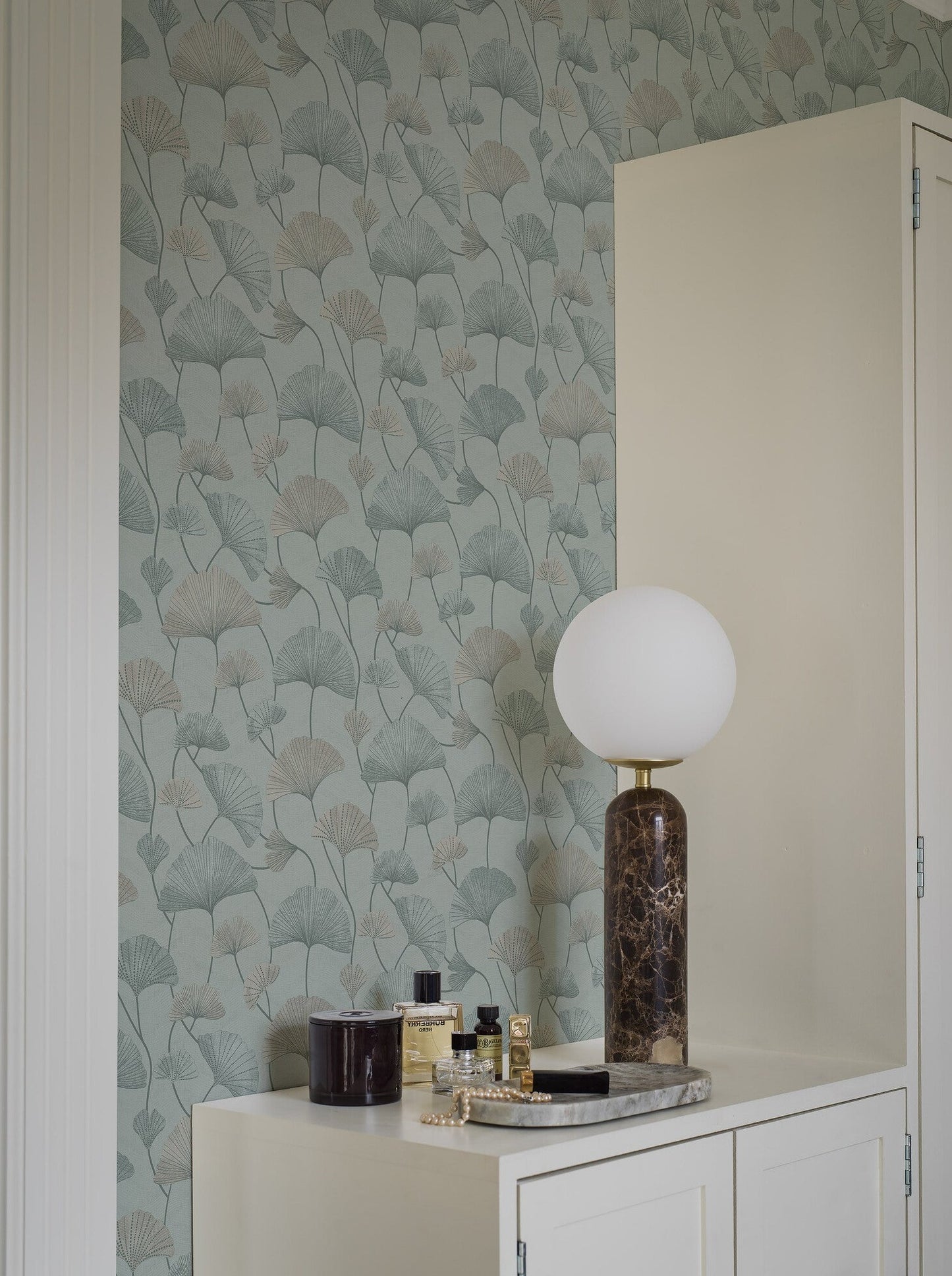 Set on a light blue background with blue, turquoise and shimmering silver, our Sophia wallpaper evokes a sense of tranquillity and serenity.