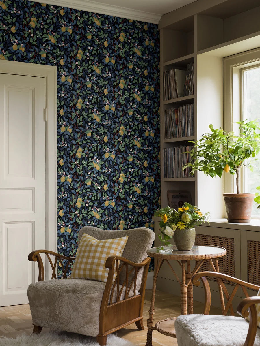 Dive into a world of color with our Citronträd wallpaper in multi-colored tones of blue, green, cream, pink, red and yellow.