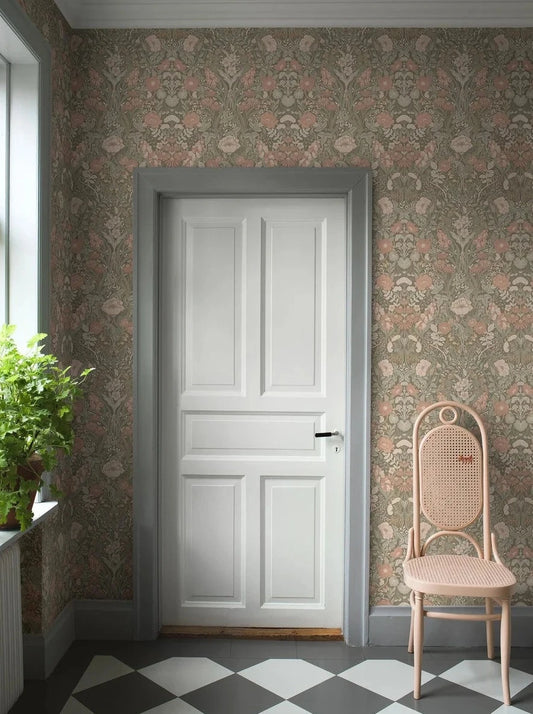 Step into the poetic and traditional beauty of our Örtagård wallpaper in powdery pink and green tones on a muted dark background.