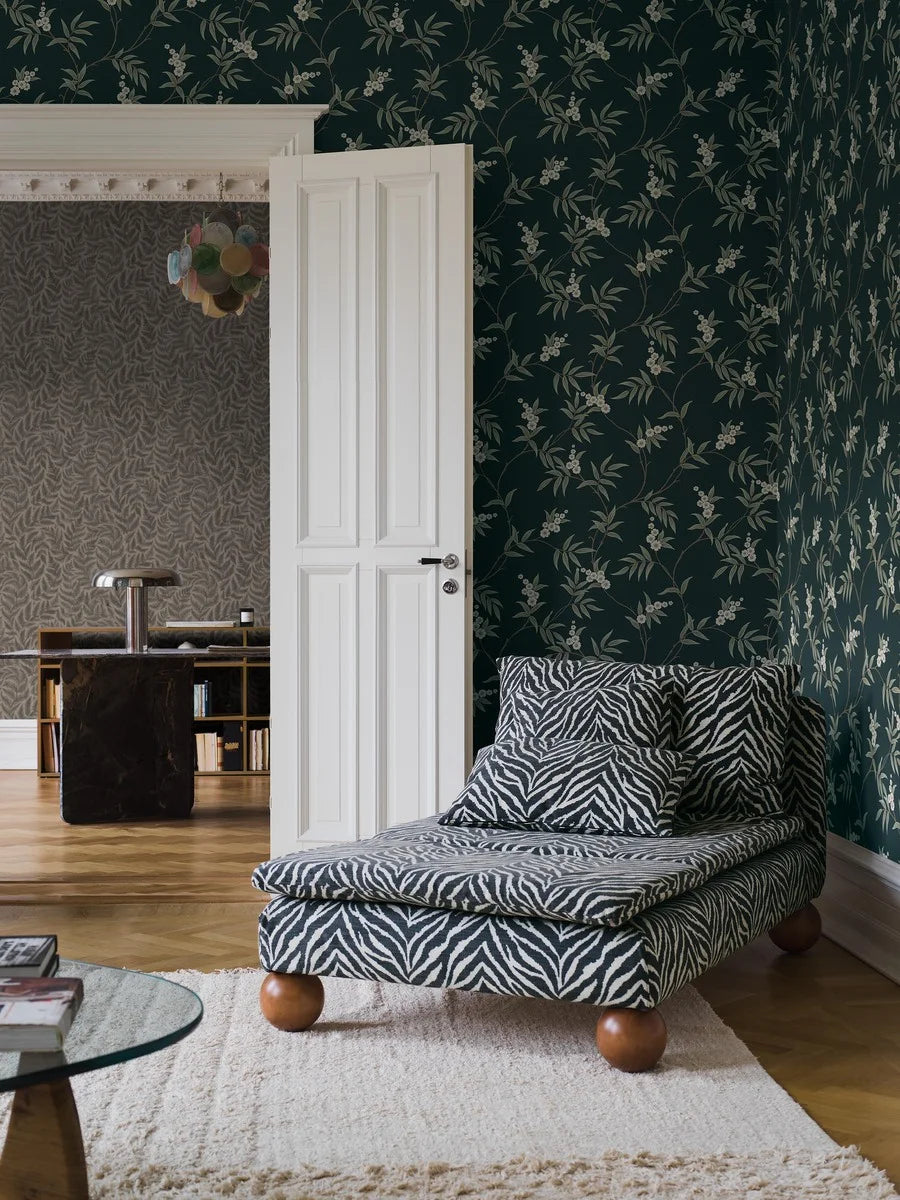 Our Floral Tree wallpaper pairs green leaves and white flowers with a charcoal black background, to create a bold, sophisticated design.