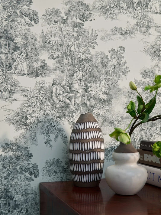 A timeless classic, our Toile de Jouy wallpaper features a muted black print on a light grey-beige background. 