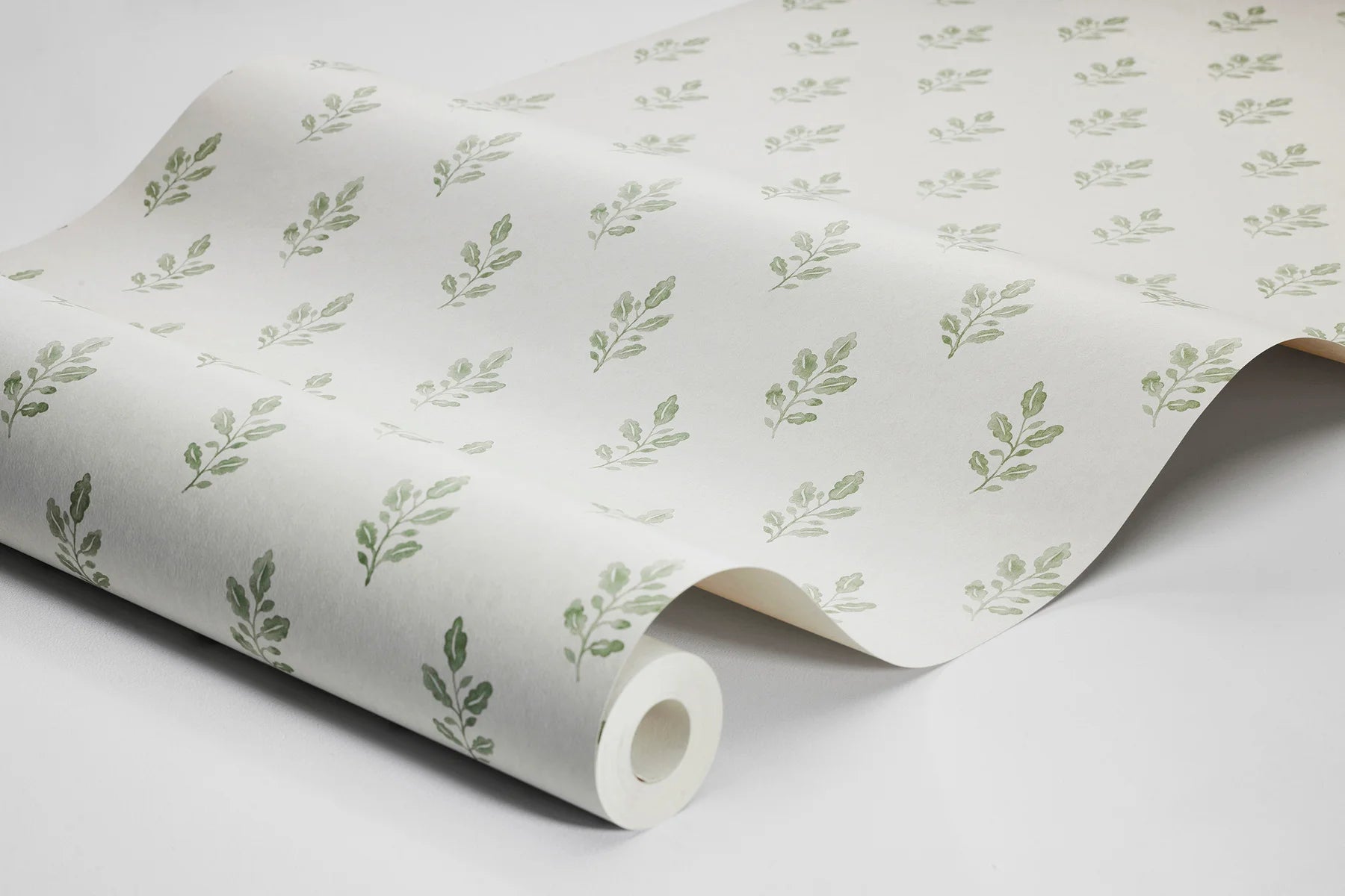 Our Little Oak wallpaper in fresh green on a creamy white base brings a lively yet soothing touch to your walls.