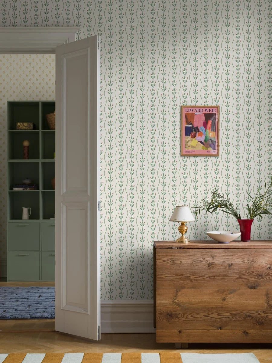 Colored in fresh leafy green tones punctuated with soft red detailing on a pure white background, our Flower Buds wallpaper brings a light, lively energy to your walls. 