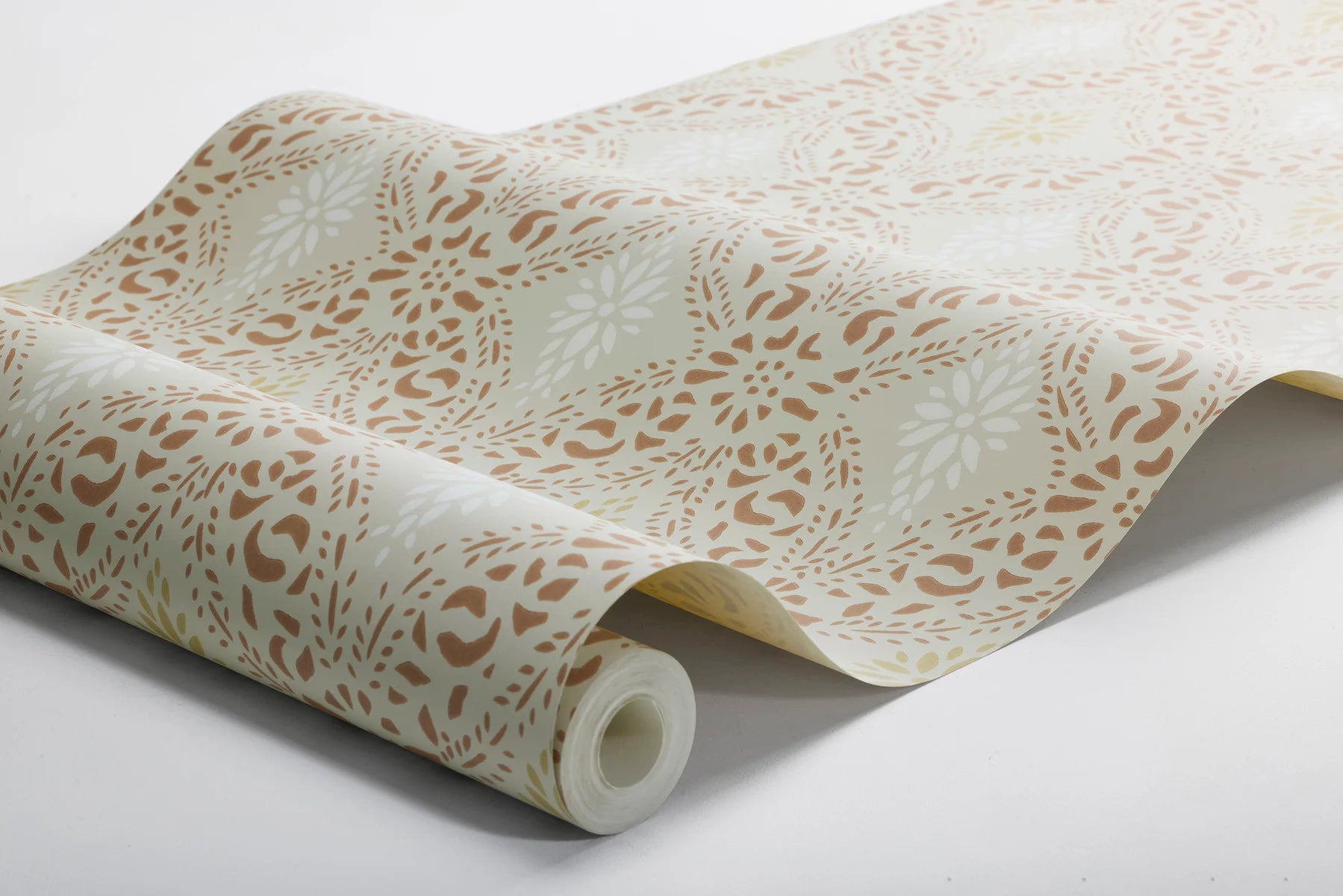 Featuring a timeless stencil pattern, our Kvarnholmen wallpaper comes alive in earthy tones of terracotta, ochre and soft white, gently layered over a warm beige background.