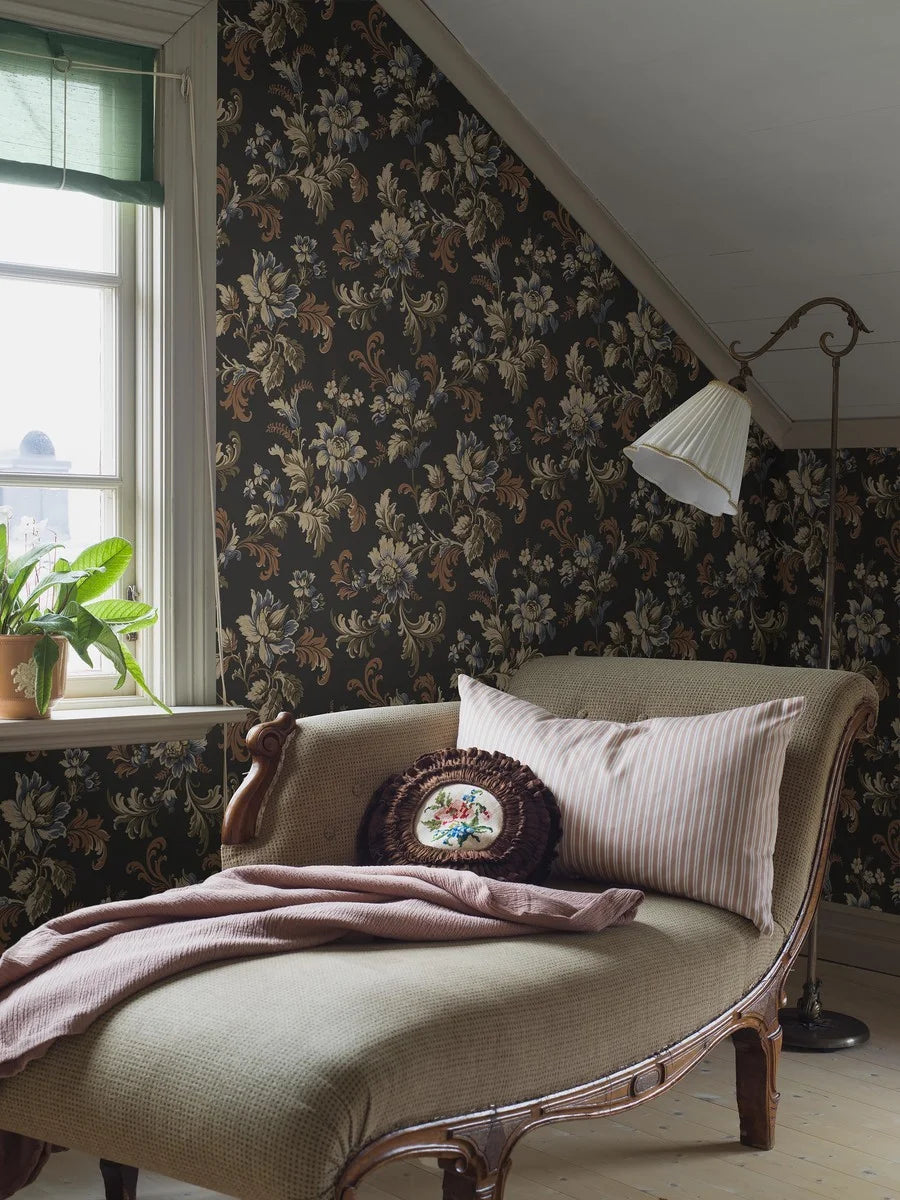 Set on a bold black background, with floral strands in tones of olive green, brown and blue, our Elvira wallpaper shimmers with golden detail.