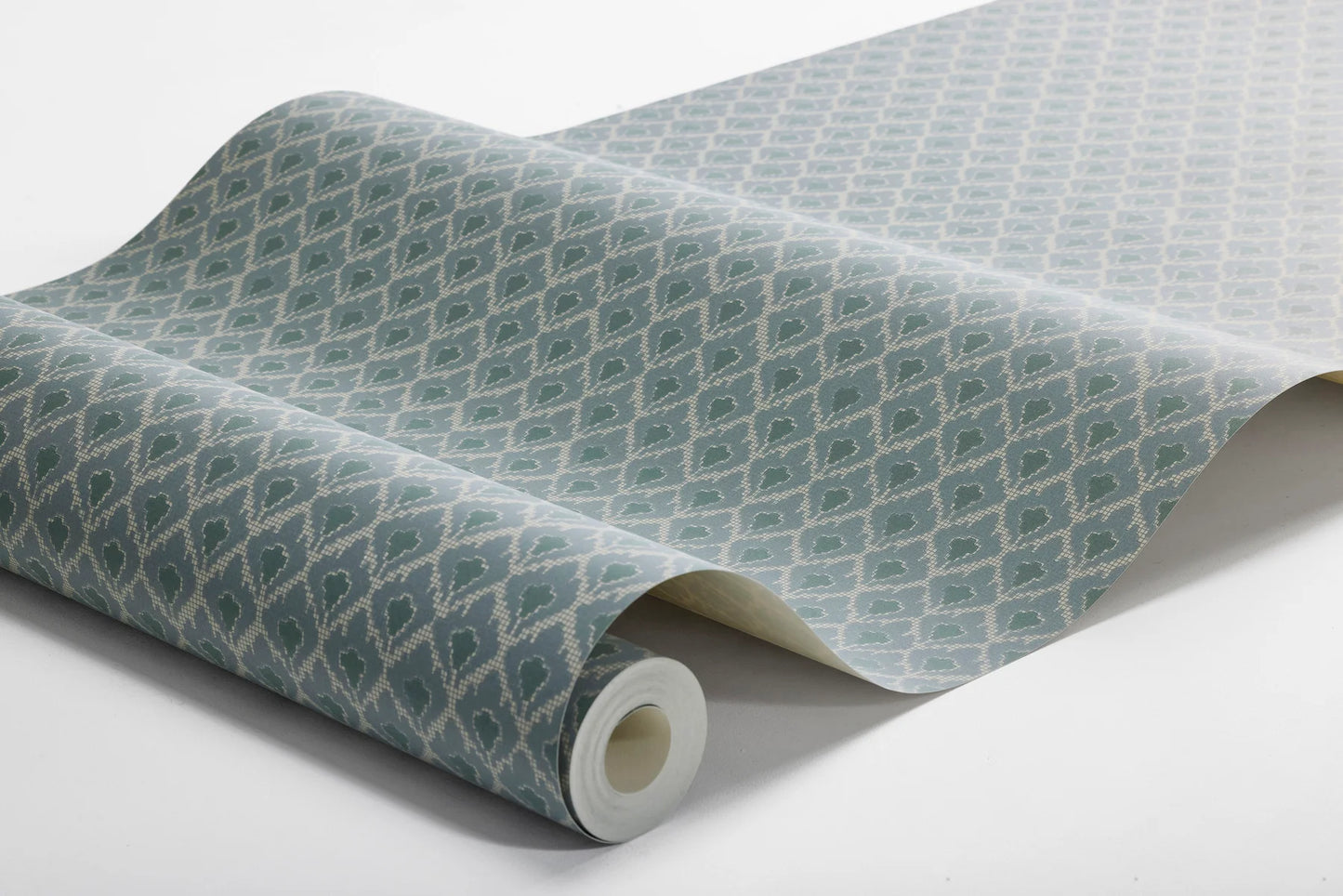  Muted blue tones pair with dark green accents in our Svea wallpaper for a nostalgic palette that is full of depth. 