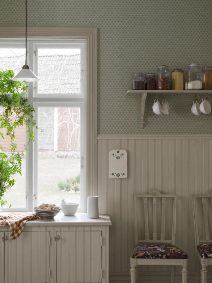  Understated, yet full of character, our Svea wallpaper is colored in a muted green palette lifted by ochre highlights that add a touch of warmth. 