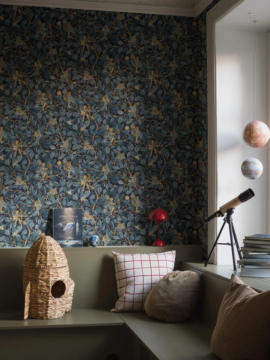 Bring a sense of mystery and enchantment to your home with our Fairies wallpaper set on a midnight blue background with blue foliage and shimmering golden details. 
