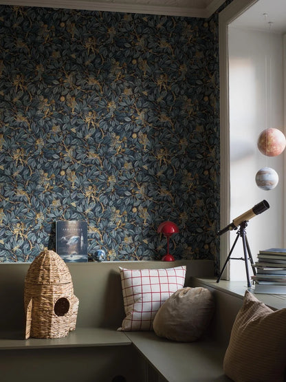 Bring a sense of mystery and enchantment to your home with our Fairies wallpaper set on a midnight blue background with blue foliage and shimmering golden details. 