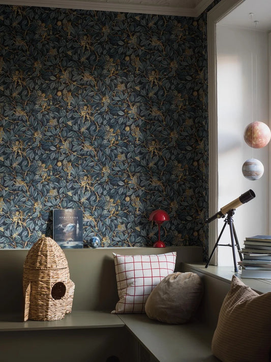 Bring a sense of mystery and enchantment to your home with our Fairies wallpaper set on a midnight blue background with blue foliage and shimmering golden details. 
