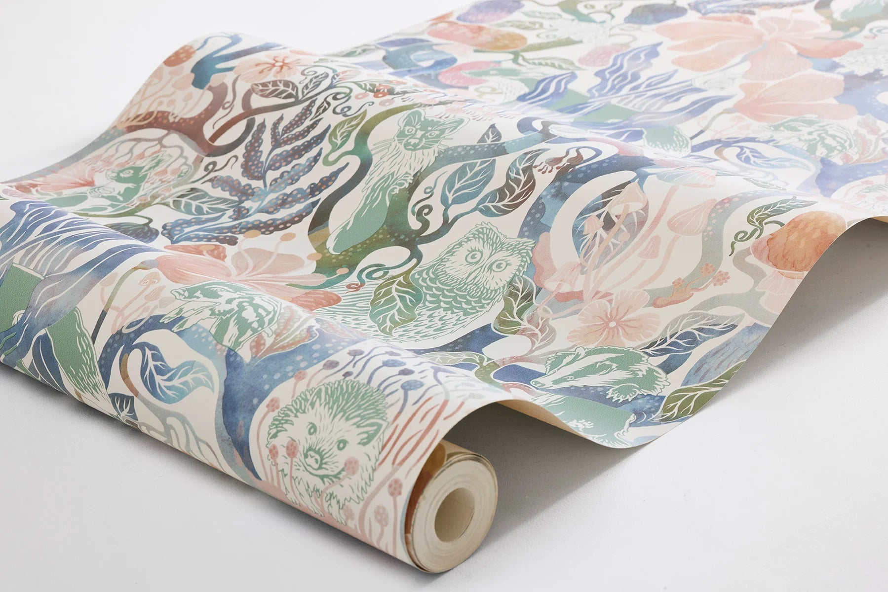 Our Magic Woods wallpaper features a dreamy woodland design in soft multi-colored pastel hues on a warm white background.