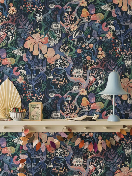 Colored in rich, dark tones of purple, pink, blue, and green on a deep blue-black background, our Magic Woods wallpaper is both organic and contemporary.