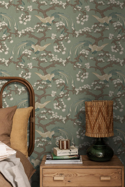 Fenix wallpaper features a deep green backdrop enriched with detailing in blue, brown and cream, creating an elegant and decorative presence on the wall.