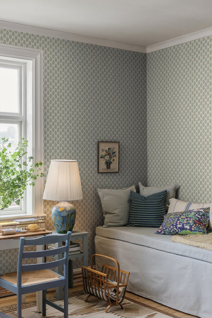 Sibylla wallpaper features small hand-drawn bouquets in gentle shades of blue and green set against a creamy white background, creating a light and calming expression.