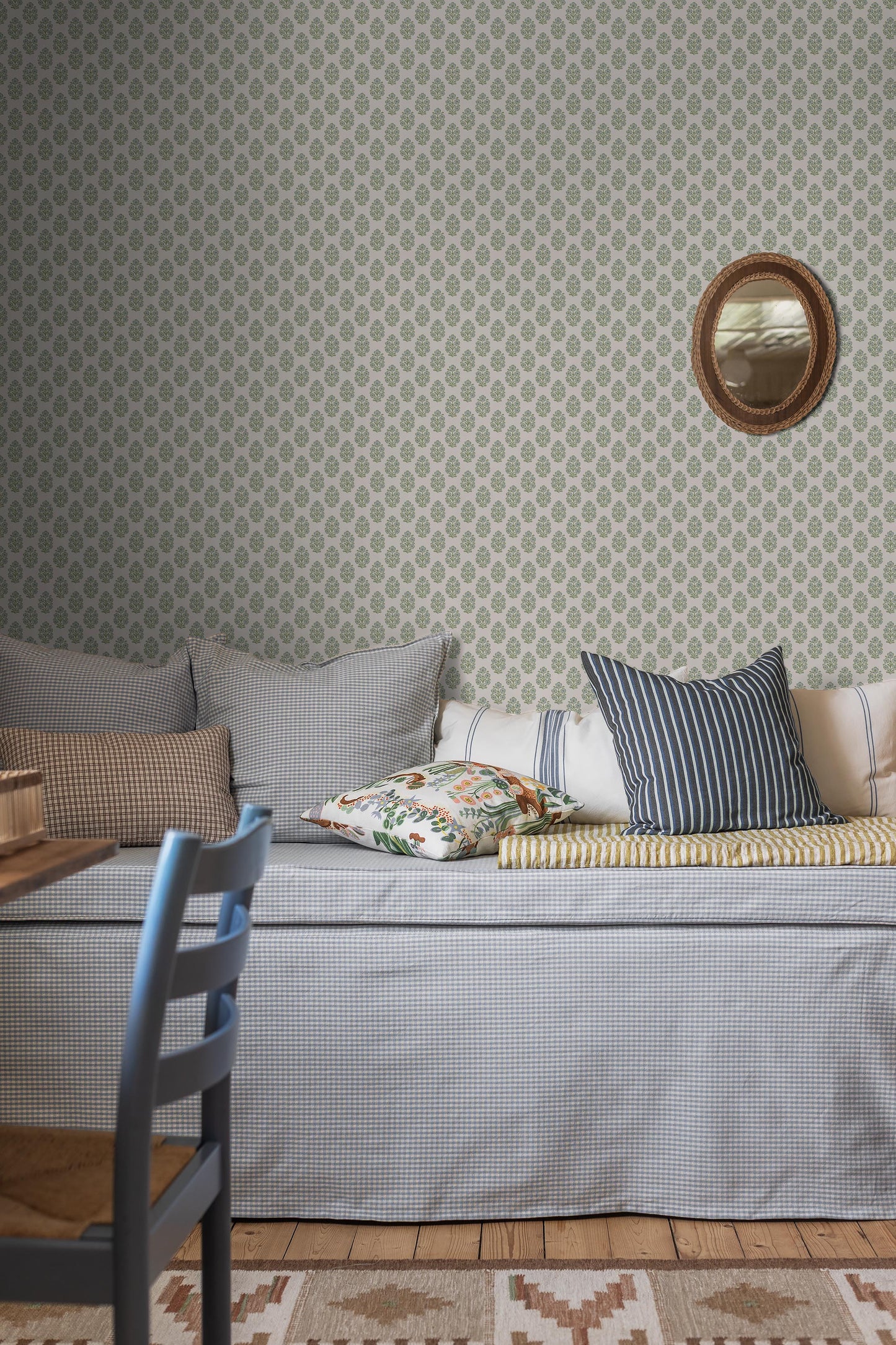 Sibylla wallpaper features small hand-drawn bouquets in gentle shades of blue and green set against a creamy white background, creating a light and calming expression.