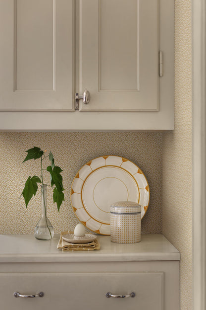 Colored in soft yellow tones, our Ida wallpaper features delicate, intertwining vines scattered with tiny leaves and subtle florals.