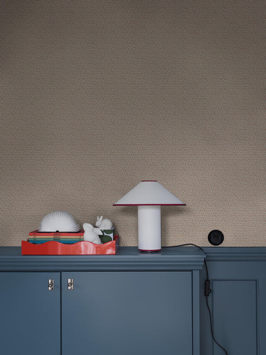 Colored in a light grey-beige tone, our Ida wallpaper reveals a delicate vine motif highlighted with pale red, grey-blue, and brown detailing. 