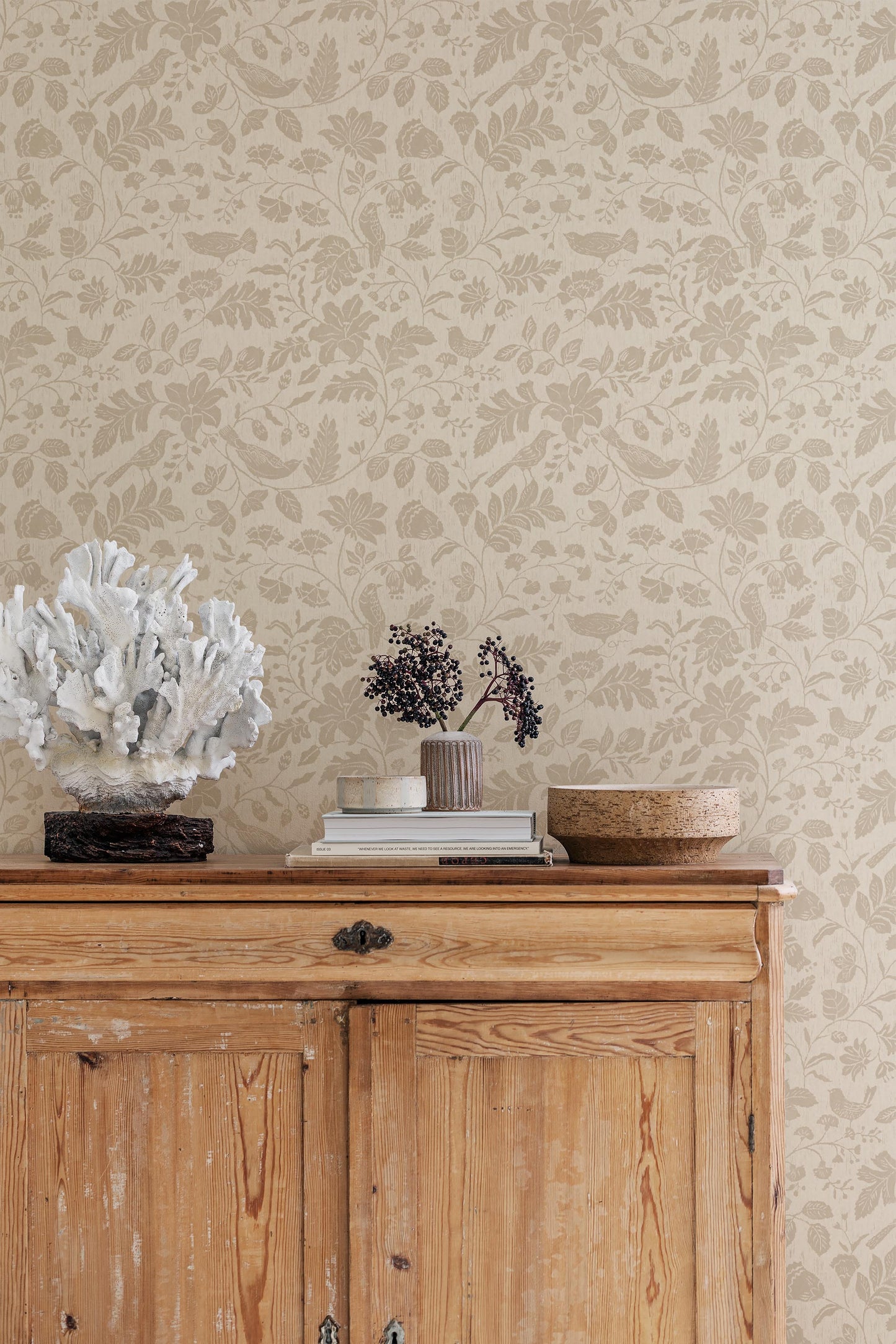Our Isidor wallpaper depicts delicate birds nestled among graceful florals and leafy branches.