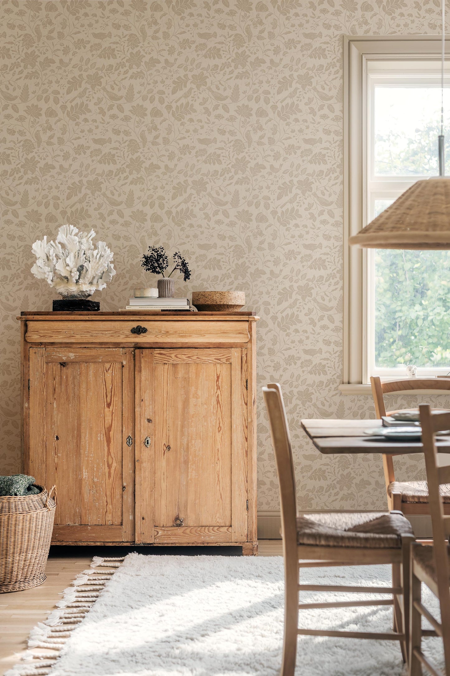 Our Isidor wallpaper depicts delicate birds nestled among graceful florals and leafy branches.