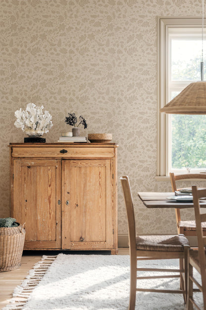 Our Isidor wallpaper depicts delicate birds nestled among graceful florals and leafy branches.