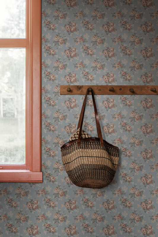 Colored in a soft sky-blue tone, our Helena wallpaper reprints a romantic archival rose design with clusters of blooms detailed in apricot, petrol blue, and cream-white.