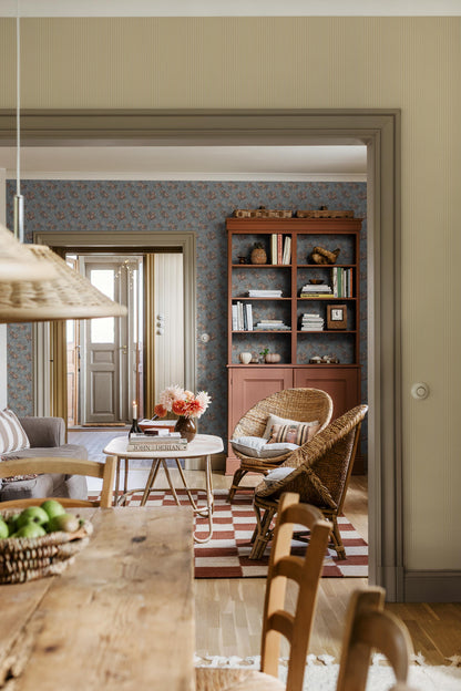 Colored in a soft sky-blue tone, our Helena wallpaper reprints a romantic archival rose design with clusters of blooms detailed in apricot, petrol blue, and cream-white.