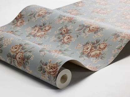 Colored in a soft sky-blue tone, our Helena wallpaper reprints a romantic archival rose design with clusters of blooms detailed in apricot, petrol blue, and cream-white.