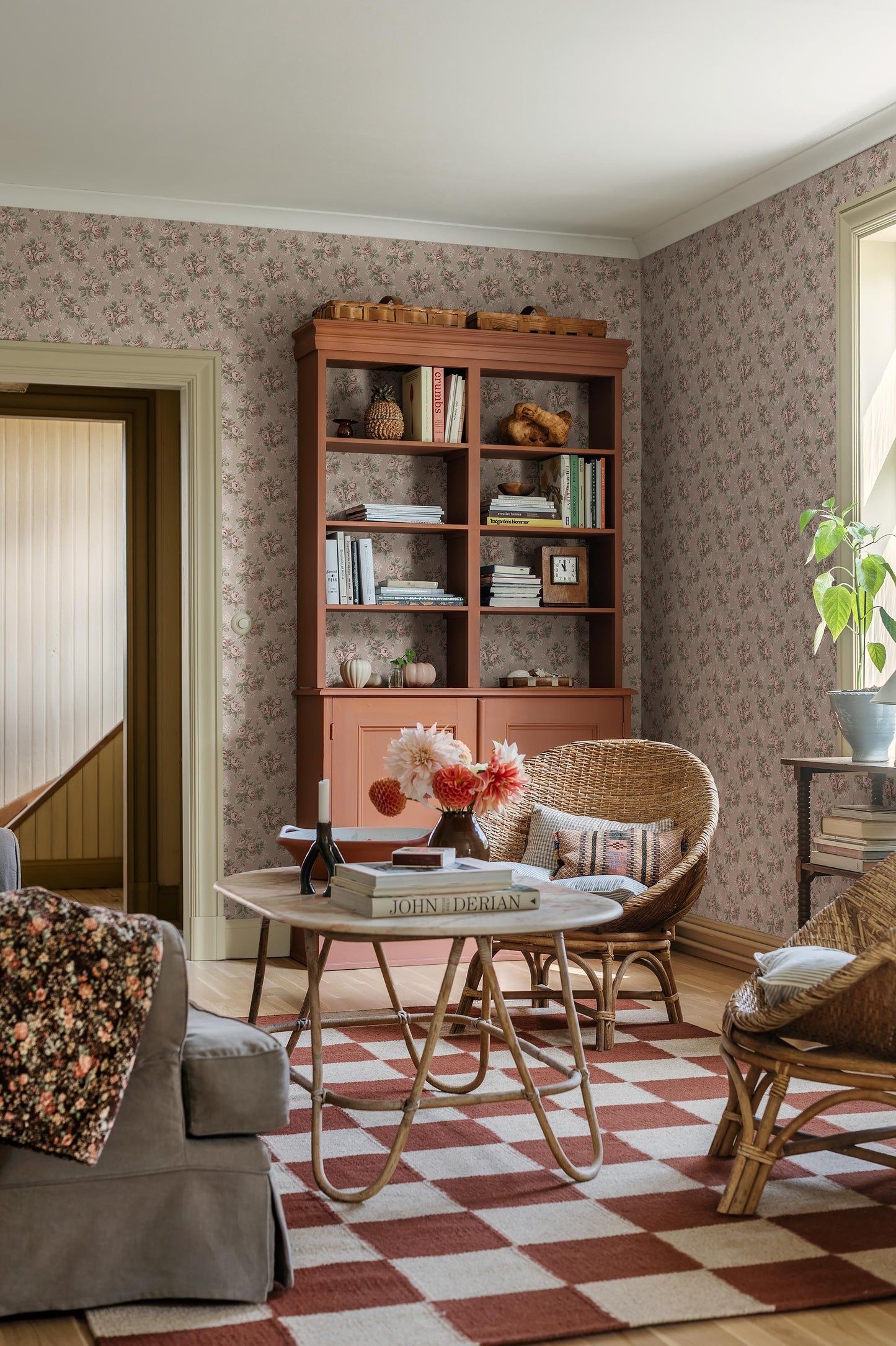 Set on a soft pink background with cool undertones, our Helena wallpaper features flowing rose bouquets in muted shades of pink, green, and cream-white. 