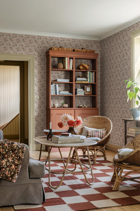 Set on a soft pink background with cool undertones, our Helena wallpaper features flowing rose bouquets in muted shades of pink, green, and cream-white. 