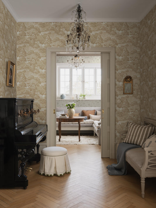  The Alnarp wallpaper is adorned with a stylized park landscape featuring large, leafy trees and beautifully arched bridges. 